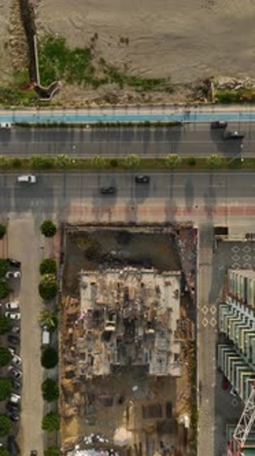 Vertical Video Construction Crew on Scaffolding Installing Facade Panels at a HighRise Residential