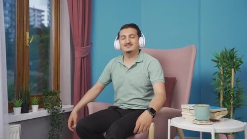 Man Listening to Music in Chair at Home