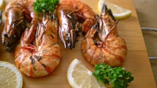 Grilled Tiger Prawns with Lemon Wedges on Serving Board