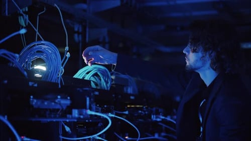 Man analysing cables in a data center