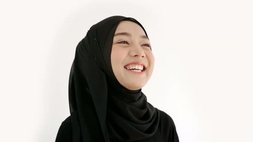 Portrait of an Asian muslim woman in a daily prayer at home in a single act of sujud called a sajdah