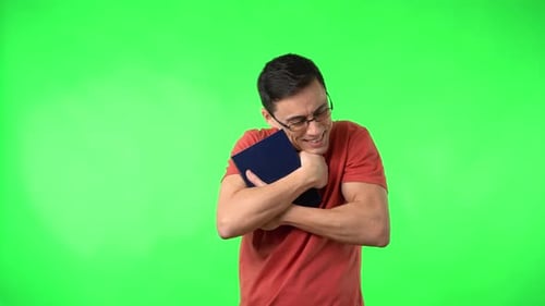 Man Hugging a Book on Green Screen