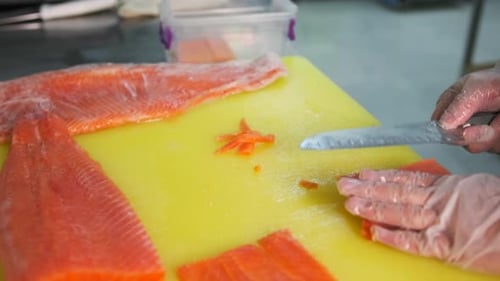 Slicing Salmon Filet on Cutting Board