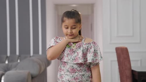 Sick Indian kid girl coughing and not feeling well