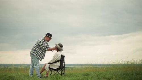 Illustrator Adjusts Woman's Hat in Serene Outdoor Setting