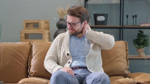 Adult Man Suffering from Neck Pain at Home