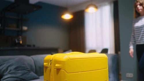 Traveller Woman Takes Her Yellow Wheeled Suitcase Leaves Home Goes to Taxi Female Tourist with