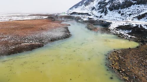 Green and thermal spring water with rocky coast
