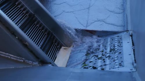 Water Flowing Into A City Street Drain