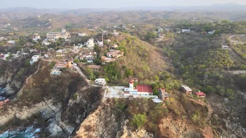 Pull front to small lighthouse of Puerto Angel, Oaxaca. From view of mountains