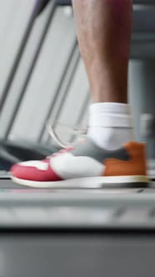Young African American Man Running on Treadmill at Gym Close Up of Legs Vertical Video