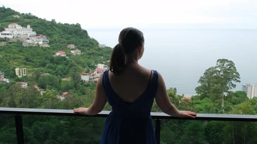 Young Woman Enjoying Scenic Sea View From Terrace