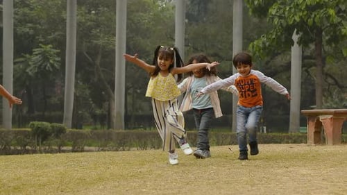 Video Of Indian Kids Running In Park waving Their Arms In The Air.