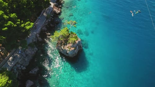 A secluded cove reveals the natural beauty and serenity of rocky coastline in Brela, Croatia. Popula