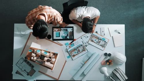 Top down view of business man and colleague design house together. Alimentation.