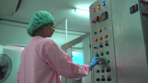 Female Engineer Operating Machinery Equipment at Factory