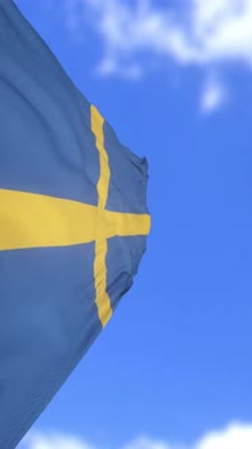Realistic Swedish Flag Waving Against Blue Sky Vertical Video