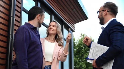 Real Estate Male Agent Giving Key From Countryside House to Happy Couple Buyer Ownership Mortgage