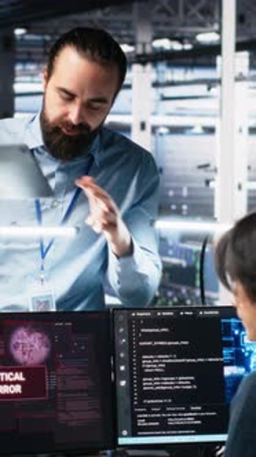 Vertical Video Data Center Manager Coordinates Programmers Fixing Critical Error While Using AI