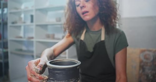 Smiling Potter Shaping Clay in Bright Studio
