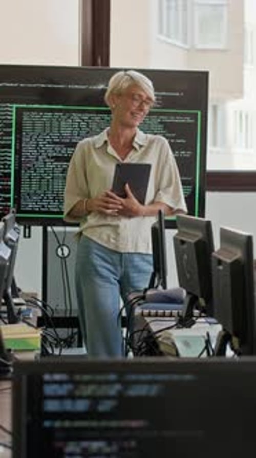Teacher Explaining Code in Computer Classroom