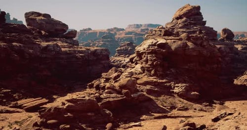 Rock Formations in a Dry Desert Landscape Under a Clear Blue Sky