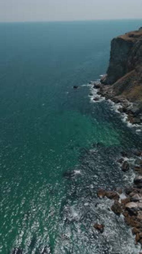Enjoy a Breathtaking Coastal View of Stunning Turquoise Waters and Majestic Cliffs Above the Ocean