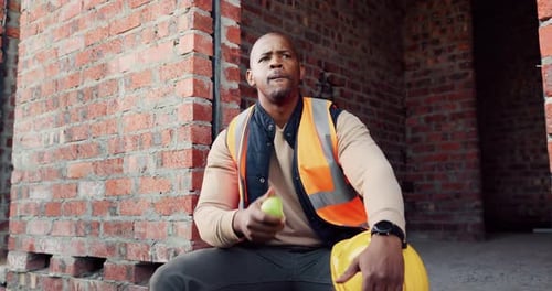 Worker, man and lunch break at construction site with building project, time management or helmet