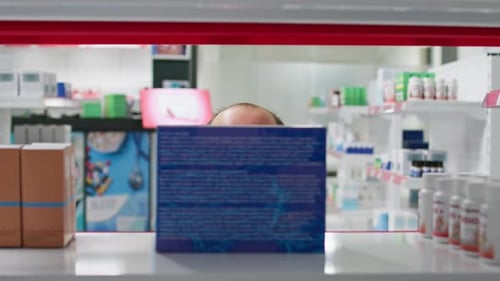 POV of Employee Putting Supplements Boxes on Display
