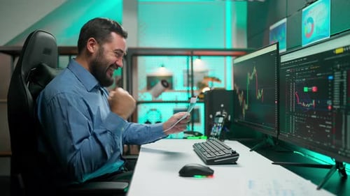 Excited Trader Works at Computer in Modern Office