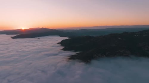 Big mountain over clouds form in a valley.