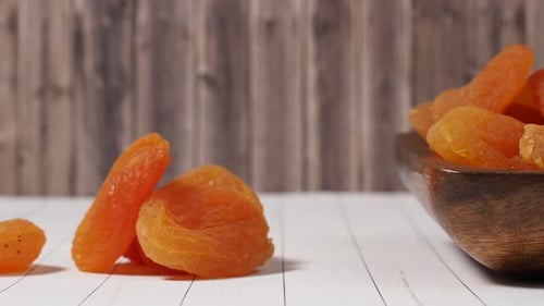 Dried Apricots in Wooden Bowl on Table