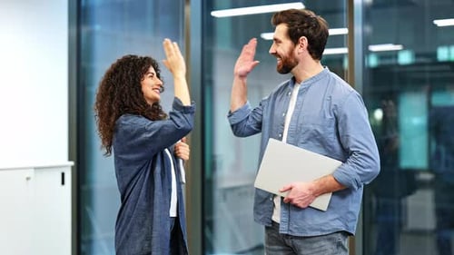 Happy Business Colleagues High Five After Successful Meeting in Modern Office