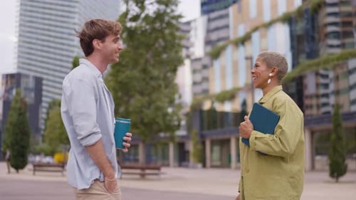 Professional Colleagues Having a Cheerful Conversation Outdoors