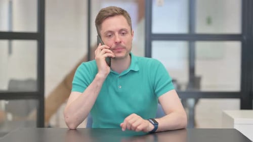 Man Answering a Call in Office Setting