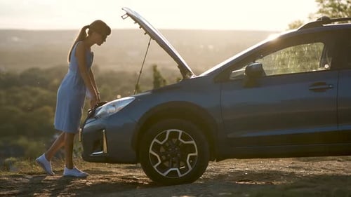 Young Woman Driver Standing Near a Broken Car with Open Hood Having Trouble with Her Vehicle
