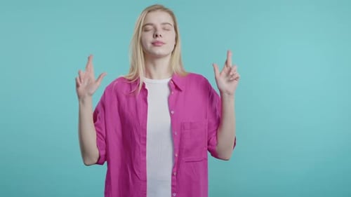 Blonde Woman Crossing Fingers Hoping For Luck