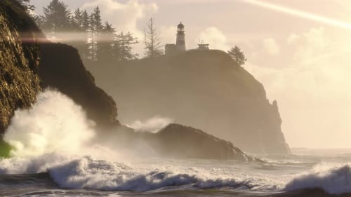 Dreamy Ocean Landscape Of Waves Crashing Rocks With Lighthouse On Cliff