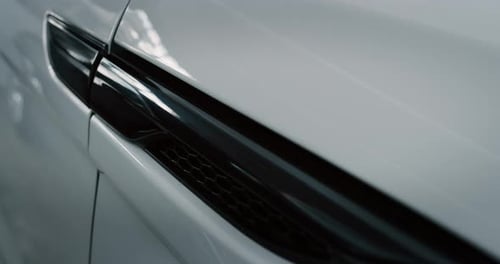 Close up of details of switched on tail lights of anonymous prestigious luxury modern car. Shot in