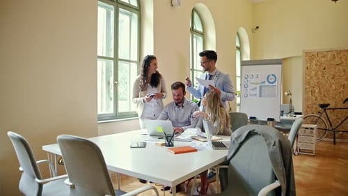 Group of business people working together while sitting at the office desk.