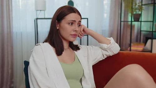 Sad Woman Sitting on Couch