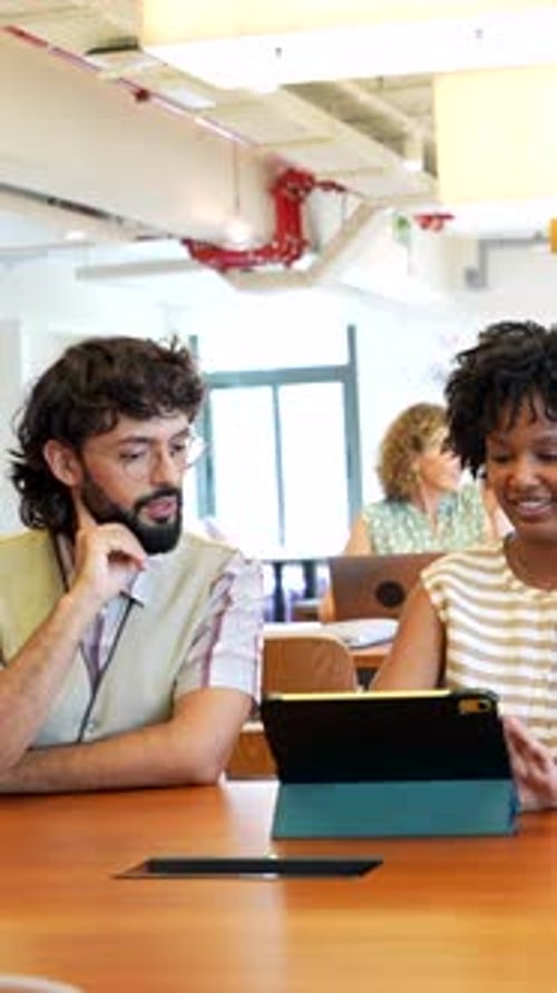 Professionals collaborate using tablet in modern office