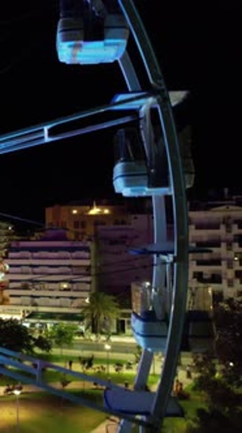 Vertical Video of Big Wheel in the City at Night