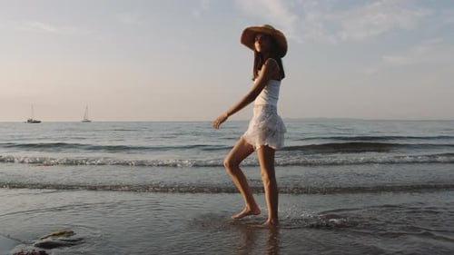 Young Woman Walking Barefoot on Peaceful Beach