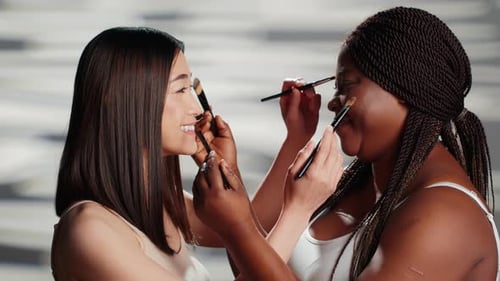 Diverse Women Playing with Make Up Brushes in Studio