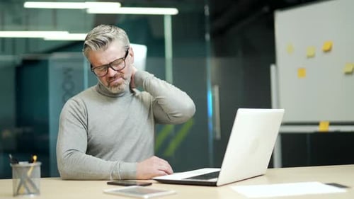 Adult Man With Neck Pain Rubbing His Neck