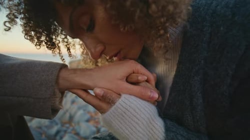 Enamoured Brunette Kissing Man Hands at Romantic Date on Ocean Coast Closeup