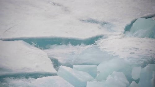 Shifting Sea Ice Floes Cracking and Colliding on Frigid Polar Waters Revealing Jagged Slabs Churning