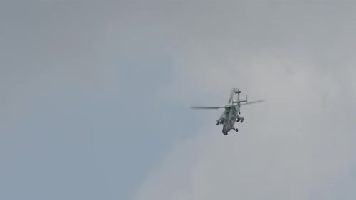 Military Helicopter Flying in Cloudy Sky