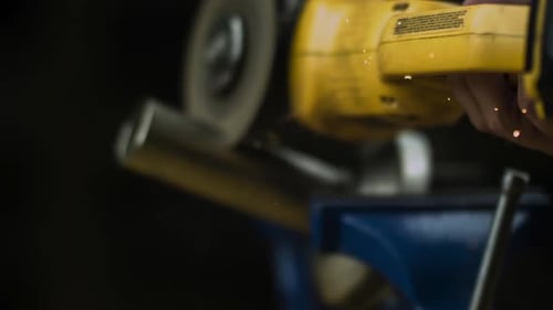 Sparks Coming Out From Angle Grinder Cutting Metal In The Workshop. - close up, slow motion
